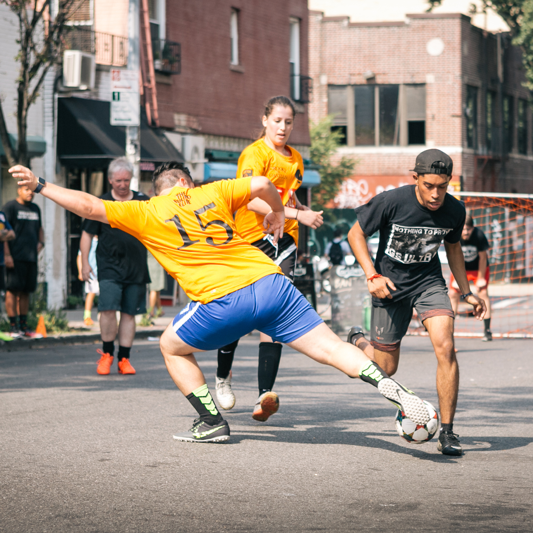Street Soccer Tournament - man stretches for the ball